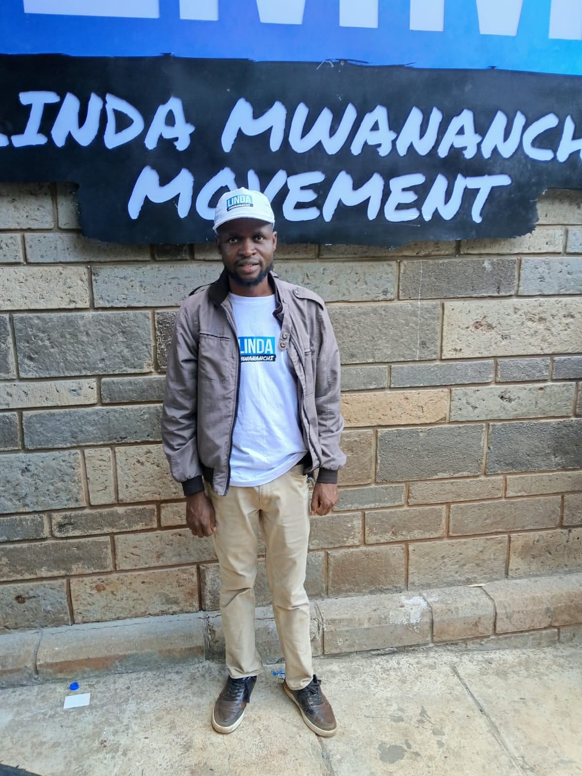 Oburenyi Harrison at the Linda Mwananchi Movement wall