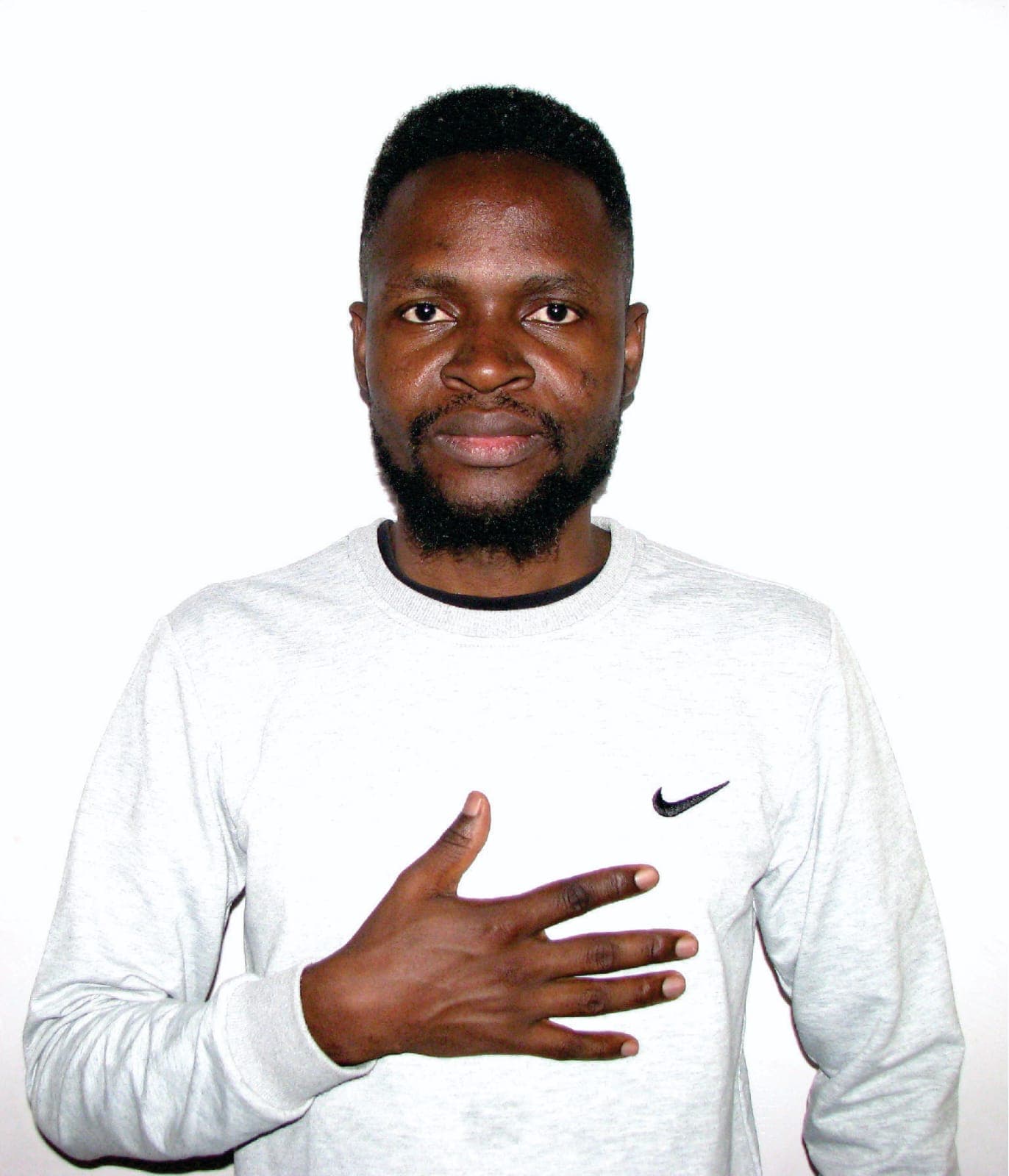 Portrait of Oburenyi Harrison, hand on heart